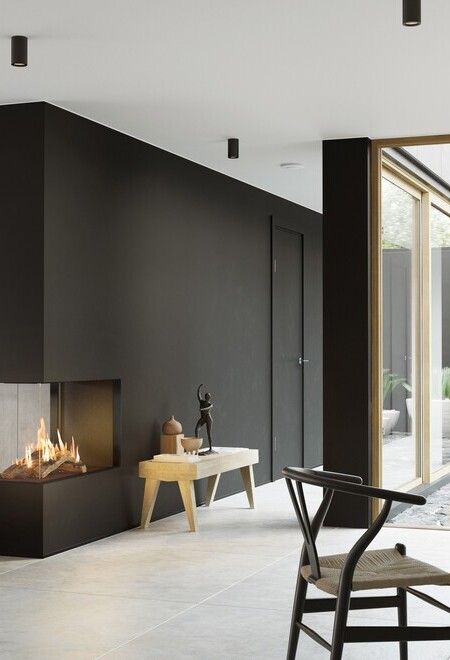 Il camino a gas VISIO 90 RD si adatta perfettamente come divisorio per ambienti in una parete nera tra il soggiorno e la sala da pranzo e dà struttura al soggiorno arredato in modo semplice