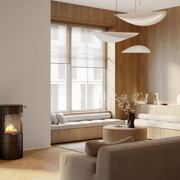 Stufa a bioetanolo VIVA 100 L in nero in un luminoso soggiorno moderno con un accogliente angolo salotto