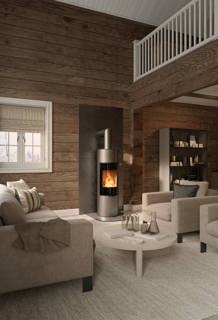 Stufa a legna VIVA 140 L in colore platino con porta del focolare in vetro pieno su una parete in legno in una casa rustica